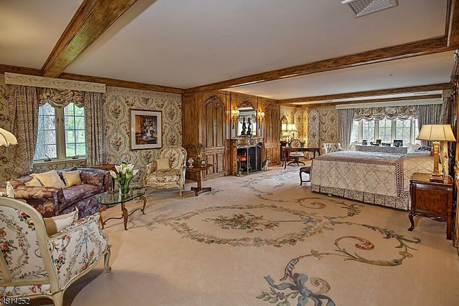 spacious bedroom with wooden beams is the setting for a luxurious bedroom.